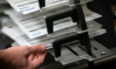 Poll workers sort out early and absentee ballots in Kenosha