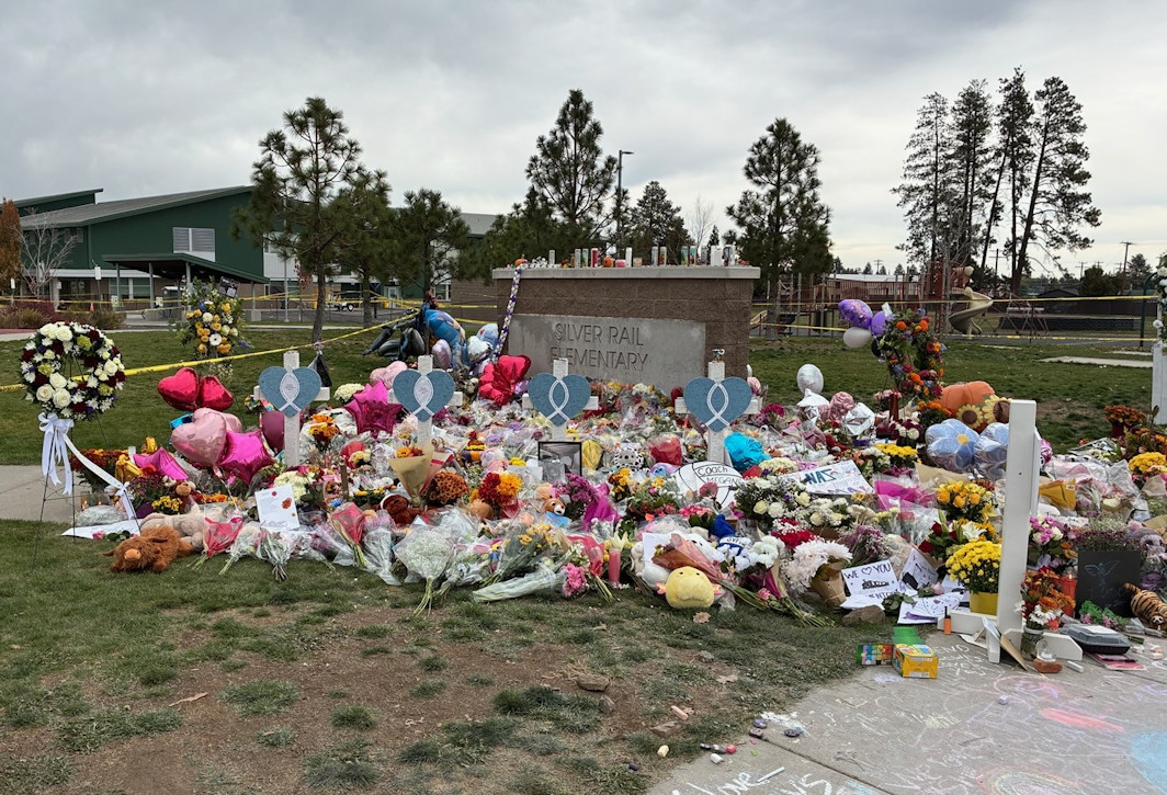 Gray clouds Monday over the growing, colorful memorial to the victims of Bend's Silver Rail Elementary School shooting.