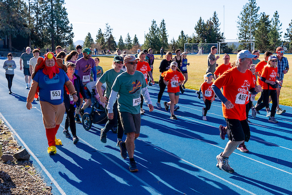 Event attendees run at the 2025 Turkey Trot 5K on COCC's Bend Campus.